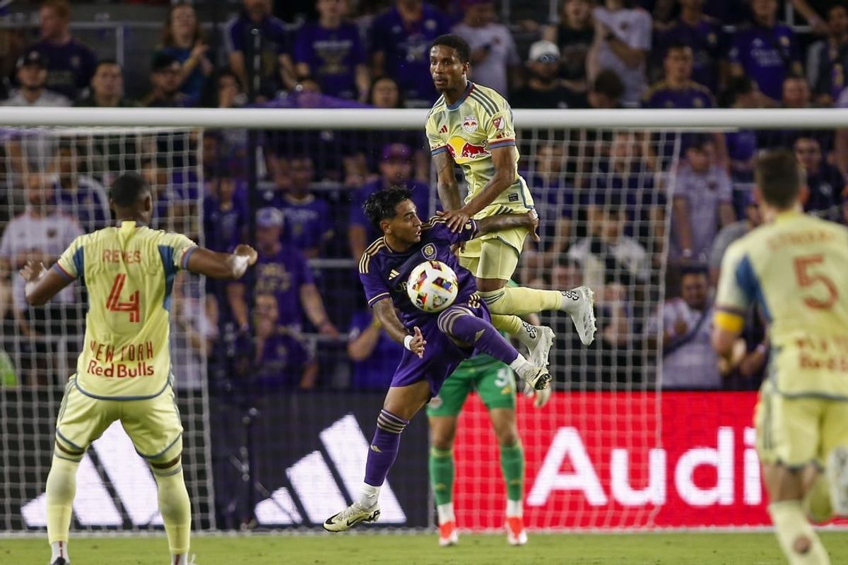 Mar 30, 2024; Orlando, Florida, USA; Orlando City midfielder Facundo Torres (10) and New York Red Bulls defender Kyle Duncan (6) battle for the ball during the first half at Inter&Co Stadium.