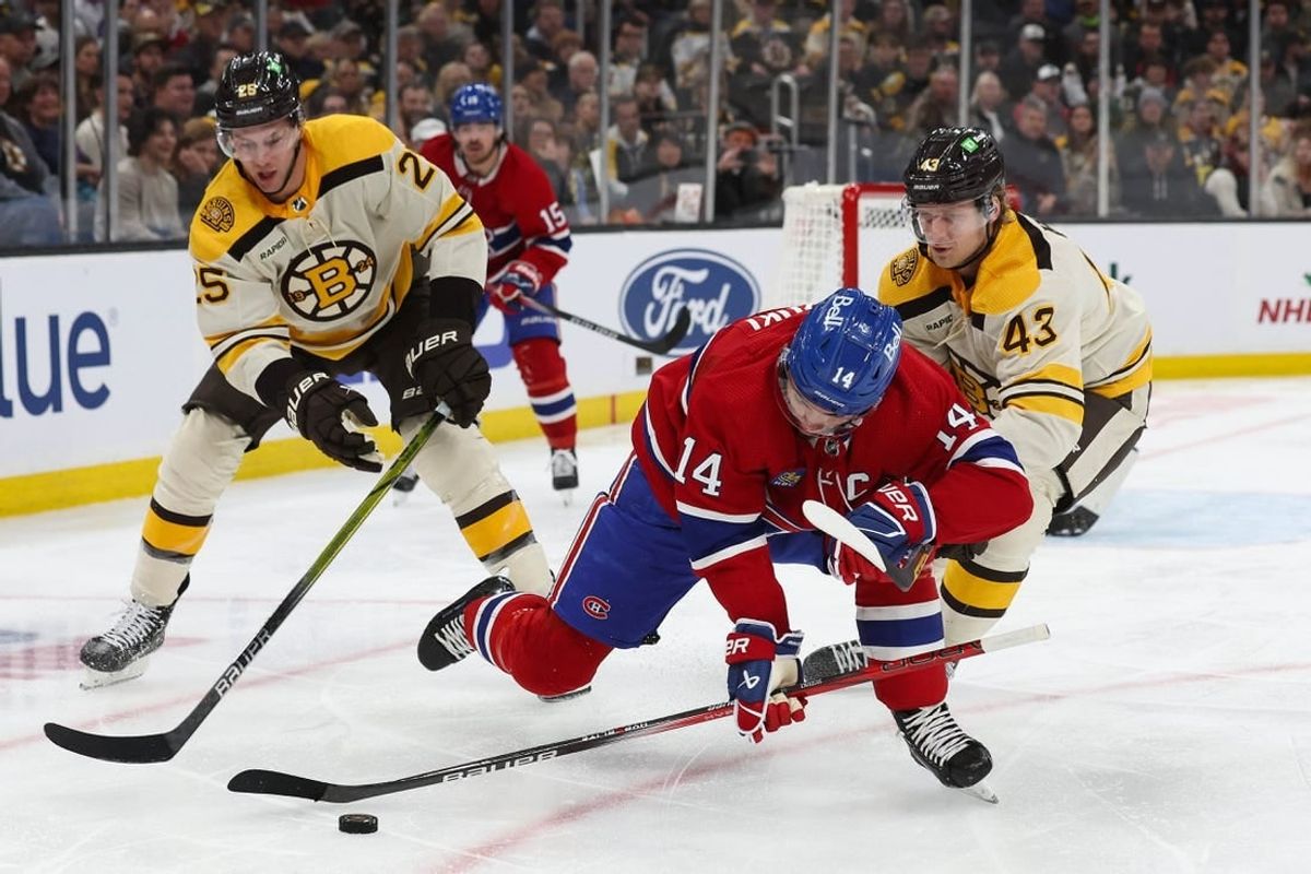 Nov 18, 2023; Boston, Massachusetts, USA; Montreal Canadiens center Nick Suzuki (14) has his hand lifted off his stick by Boston Bruins center Danton Heinen (43) during the first period at TD Garden.