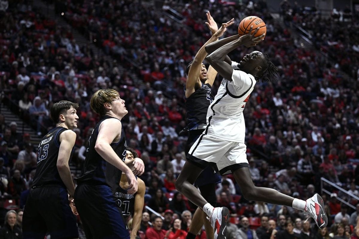 Dec 9, 2023; San Diego, California, USA; San Diego State Aztecs forward Jay Pal (4) shoots the ball against UC Irvine Anteaters guard Andre Henry (4) during the first half at Viejas Arena.