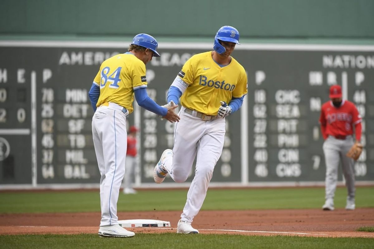 Apr 13, 2024; Boston, Massachusetts, USA;  Boston Red Sox third base coach Kyle Hudson (84) congratulates first base Triston Casas (36) after hitting a two-run home run during the first inning against the Los Angeles Angels at Fenway Park.