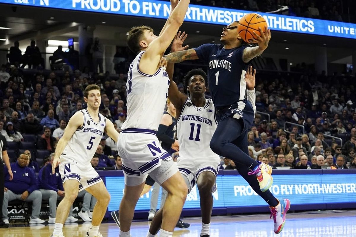 Feb 11, 2024; Evanston, Illinois, USA; Northwestern Wildcats forward Luke Hunger (33) defends Penn State Nittany Lions guard Ace Baldwin Jr. (1) during the first half at Welsh-Ryan Arena.