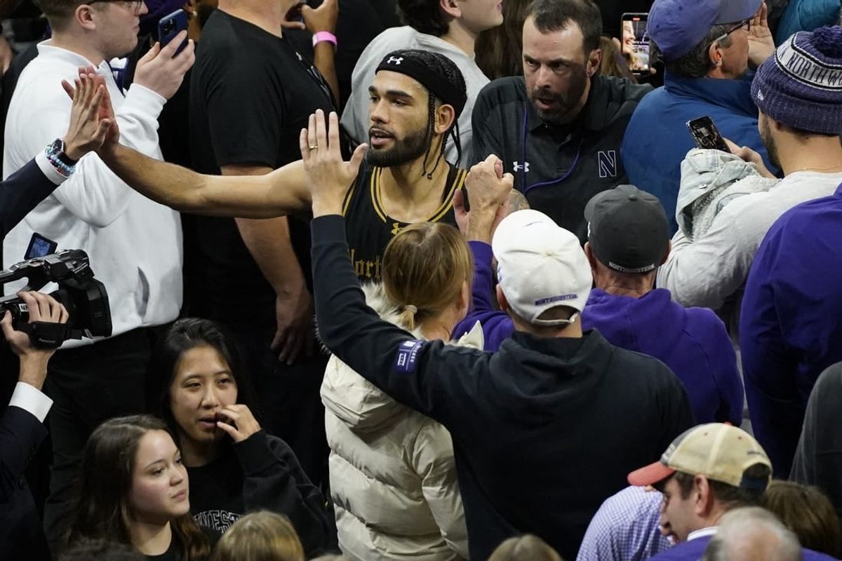 Dec 1, 2023; Evanston, Illinois, USA; Northwestern Wildcats guard Boo Buie (0) celebrates Northwestern   s overtime win against the Purdue Boilermakers at Welsh-Ryan Arena.