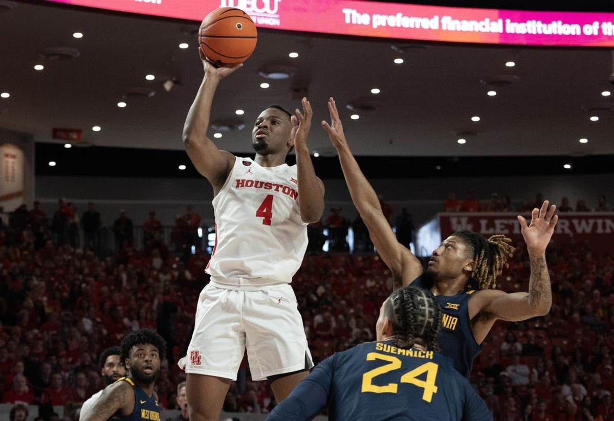 Jan 6, 2024; Houston, Texas, USA; Houston Cougars guard L.J. Cryer (4) shoots against West Virginia Mountaineers guard Noah Farrakhan (1) in the first half  at Fertitta Center.