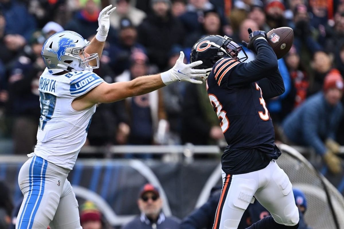 Dec 10, 2023; Chicago, Illinois, USA;  Chicago Bears defensive back Jaylon Johnson (33) intercepts a pass intended for Detroit Lions tight end Sam LaPorta (87) in the first half at Soldier Field.