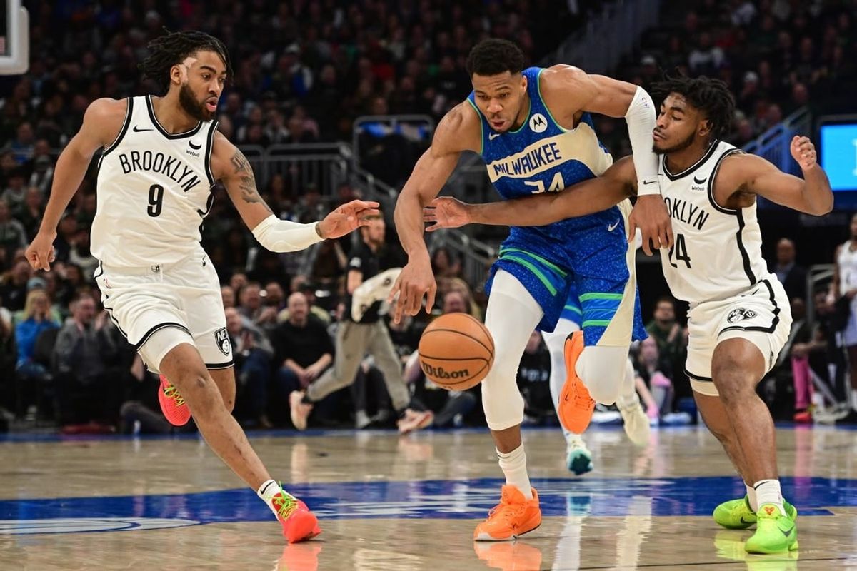 Mar 21, 2024; Milwaukee, Wisconsin, USA; Milwaukee Bucks forward Giannis Antetokounmpo (34) drives for the basket between Brooklyn Nets forward Trendon Watford (9) and guard Cameron Thomas (24) in the second quarter at Fiserv Forum.