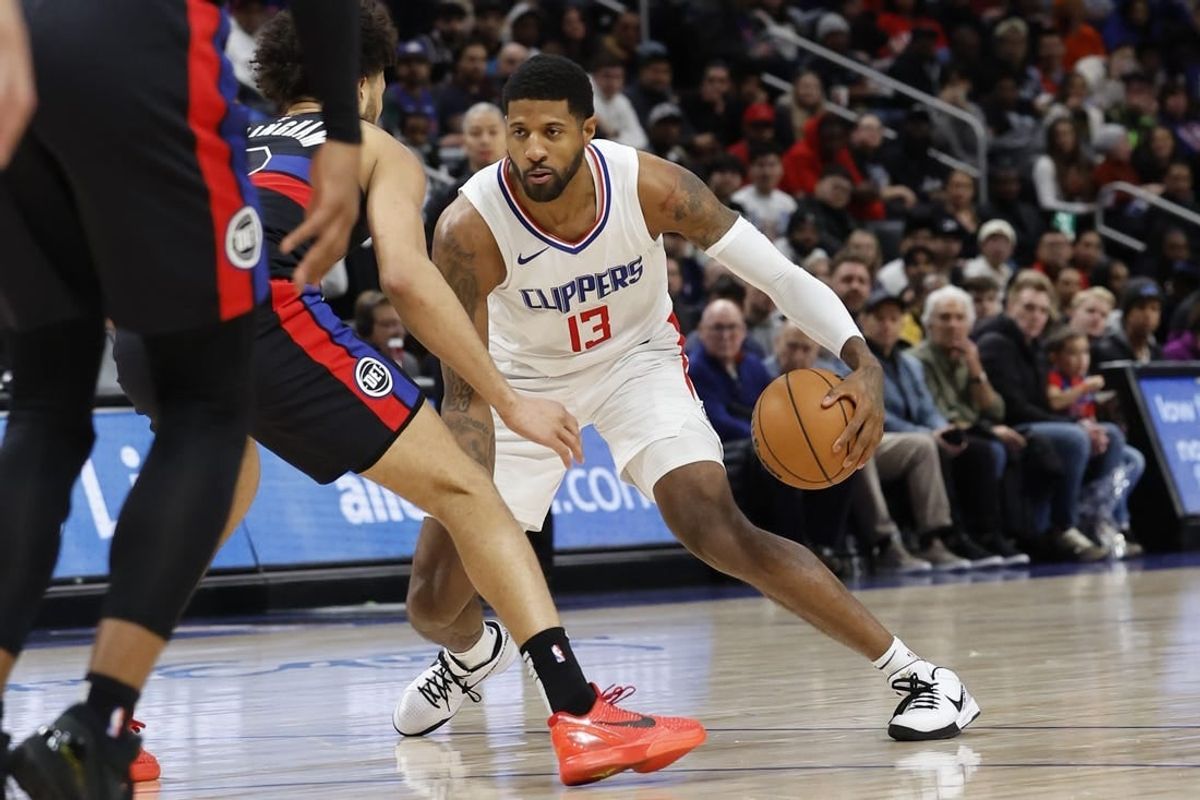 Feb 2, 2024; Detroit, Michigan, USA;  LA Clippers forward Paul George (13) dribbles defended by Detroit Pistons guard Cade Cunningham (2) in the first half at Little Caesars Arena.