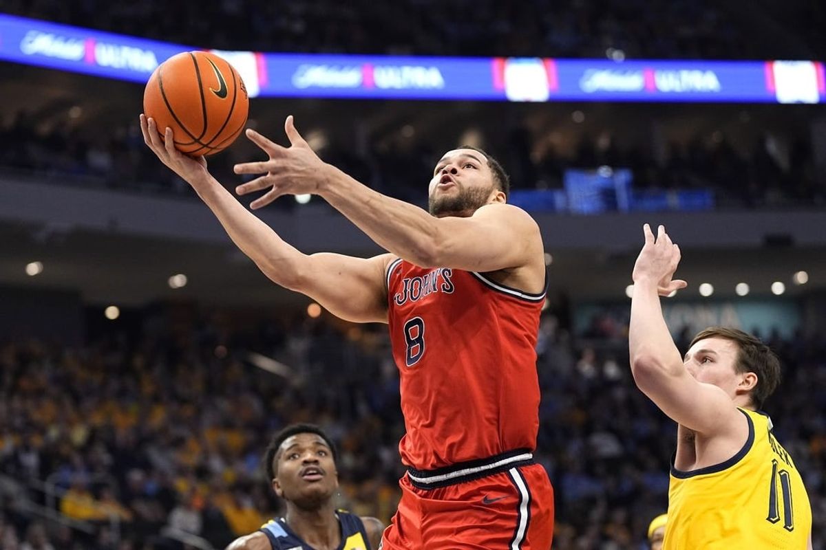 Feb 10, 2024; Milwaukee, Wisconsin, USA;  St. John's Red Storm guard Chris Ledlum (8) shoots  in front of Marquette Golden Eagles guard Tyler Kolek (11) during the first half at Fiserv Forum.
