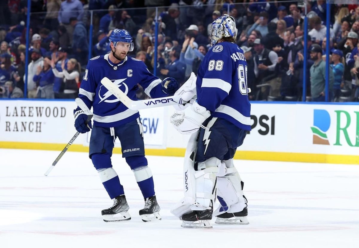 Jan 11, 2024; Tampa, Florida, USA; Tampa Bay Lightning center Steven Stamkos (91) and goaltender Andrei Vasilevskiy (88) celebrate after they beat the New Jersey Devils during overtime at Amalie Arena.