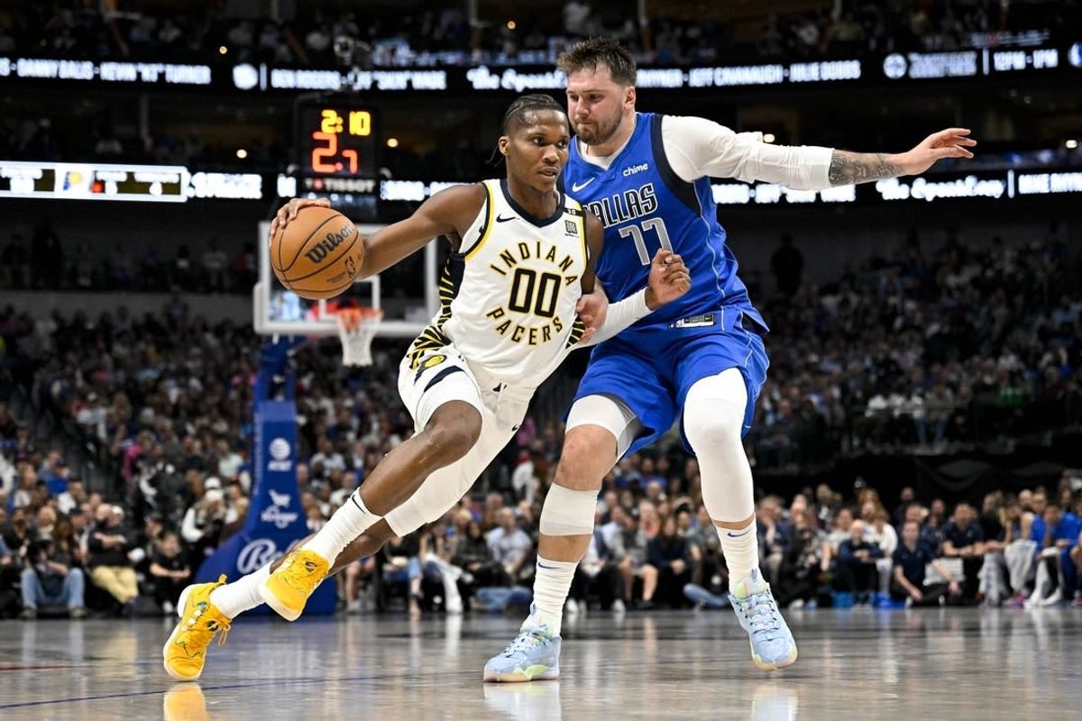 Mar 5, 2024; Dallas, Texas, USA; Indiana Pacers guard Bennedict Mathurin (00) brings the ball up court past Dallas Mavericks guard Luka Doncic (77) during the second half at the American Airlines Center.