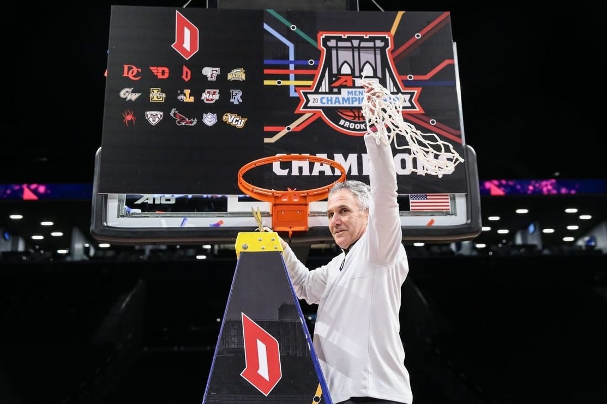 Mar 17, 2024; Brooklyn, NY, USA;  Duquesne Dukes head coach Keith Dambrot cuts the nets after winning the Atlantic 10 Tournament Championship at Barclays Center.