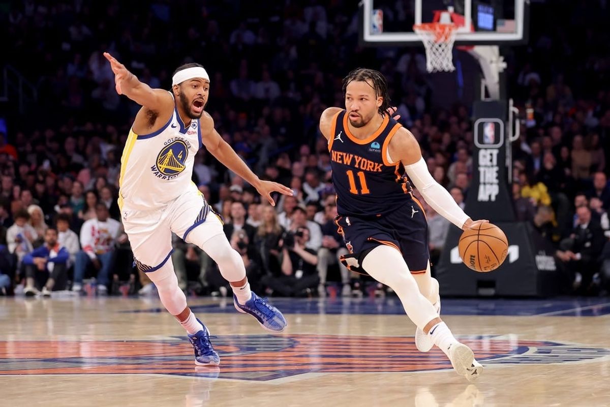 Feb 29, 2024; New York, New York, USA; New York Knicks guard Jalen Brunson (11) controls the ball against Golden State Warriors guard Moses Moody (4) during the first quarter at Madison Square Garden.