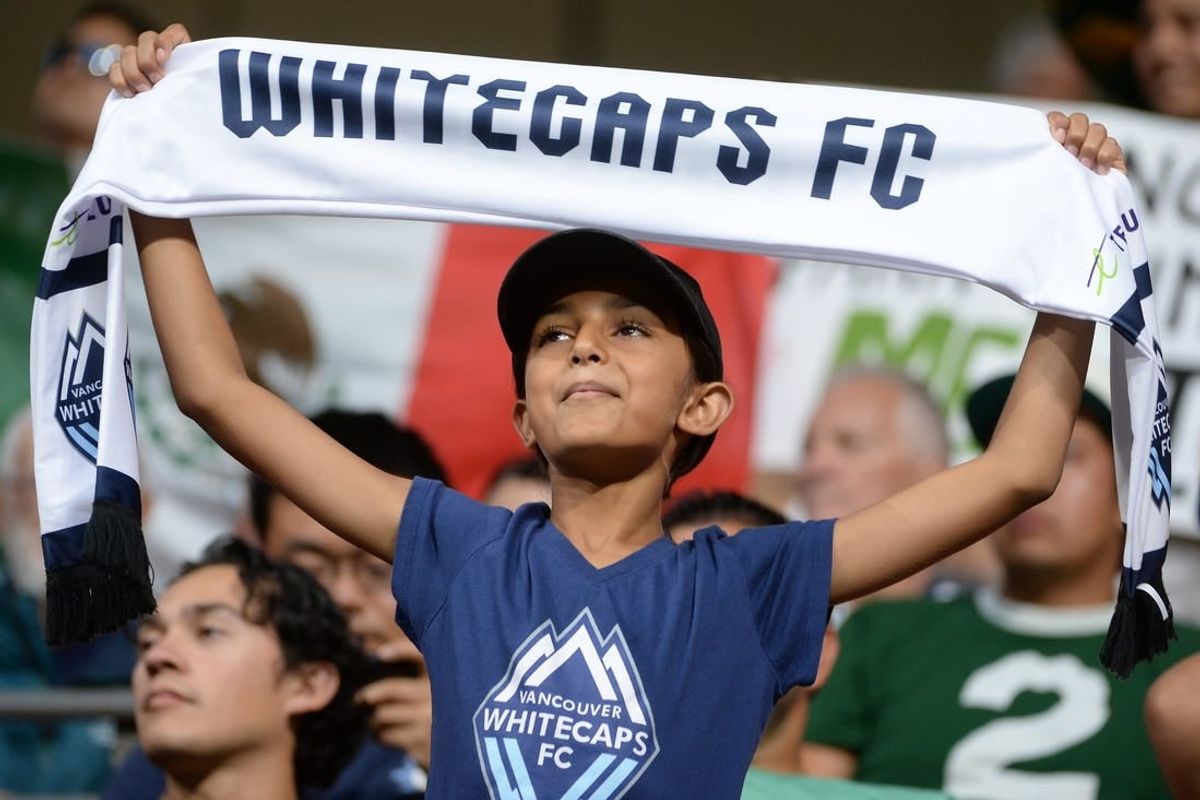 Jul 21, 2023; Vancouver, British Columbia, CAN; A young Vancouver Whitecaps fan is seen holding a scarf during the second half between the Vancouver Whitecaps and Club Leon at BC Place.