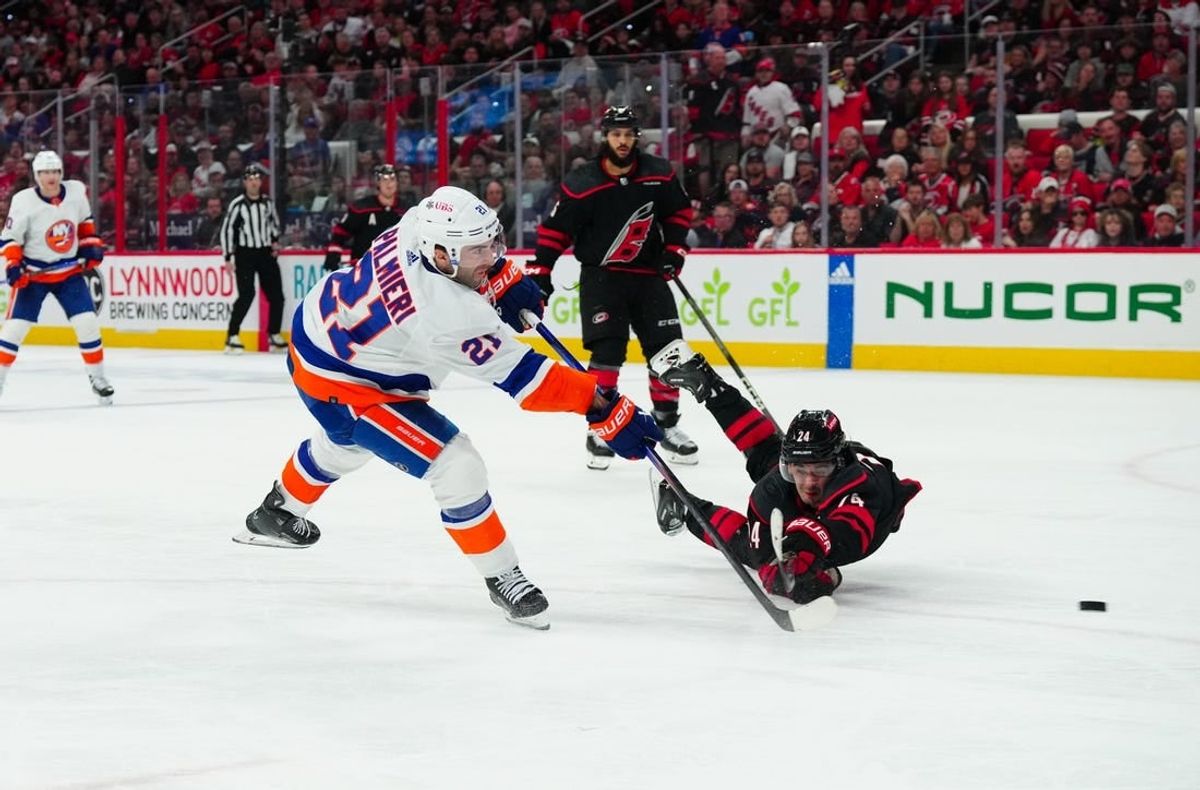 Apr 20, 2024; Raleigh, North Carolina, USA; New York Islanders center Kyle Palmieri (21) gets the shot past Carolina Hurricanes center Seth Jarvis (24) during the second period in game one of the first round of the 2024 Stanley Cup Playoffs at PNC Arena.