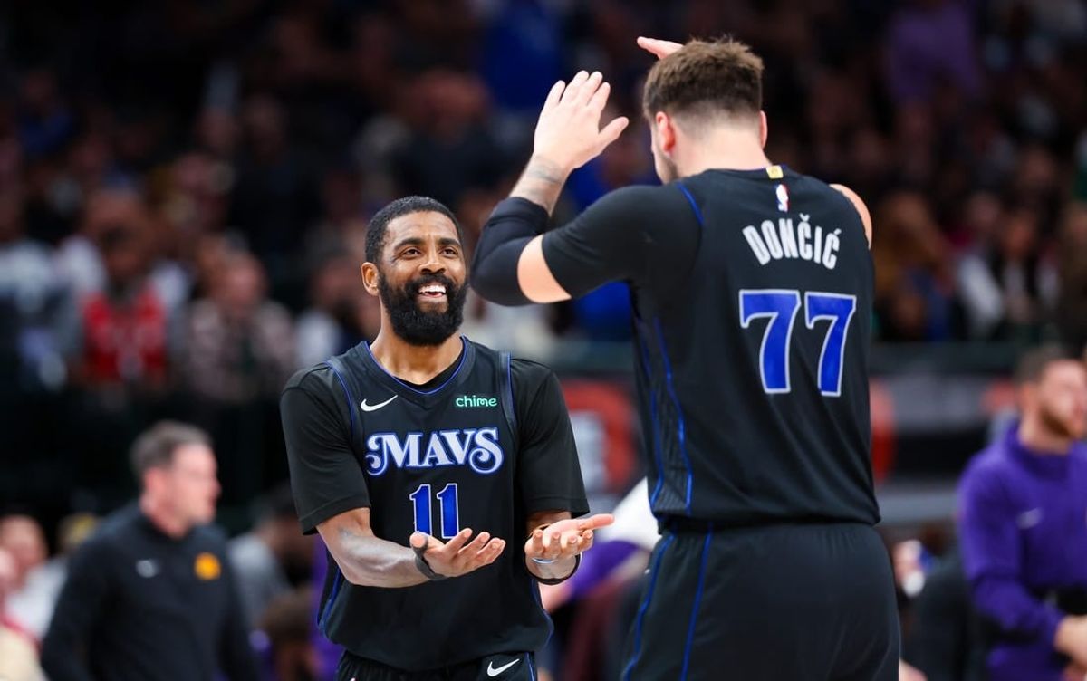 Feb 22, 2024; Dallas, Texas, USA;  Dallas Mavericks guard Kyrie Irving (11) celebrates with Dallas Mavericks guard Luka Doncic (77) during the second half against the Phoenix Suns at American Airlines Center.