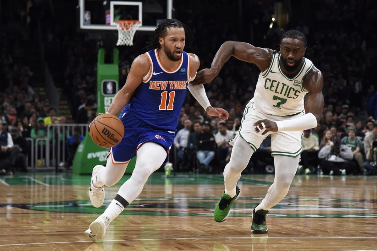 Apr 11, 2024; Boston, Massachusetts, USA;  New York Knicks guard Jalen Brunson (11) controls the ball while Boston Celtics guard Jaylen Brown (7) defends during the first half at TD Garden.