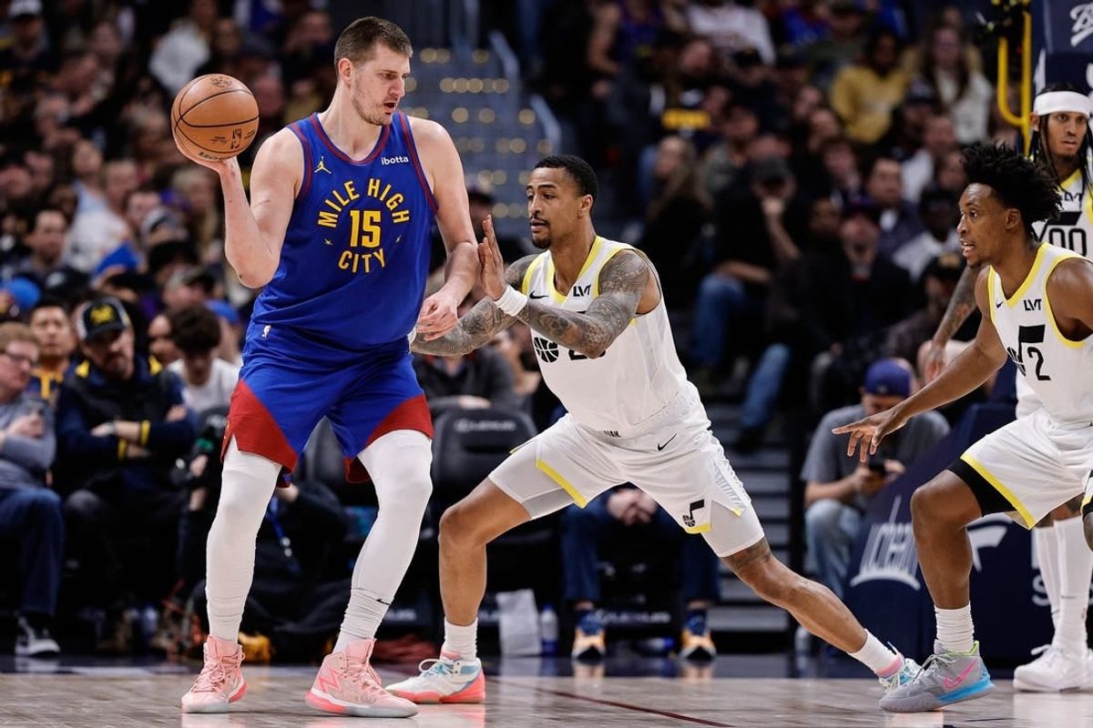 Mar 9, 2024; Denver, Colorado, USA; Denver Nuggets center Nikola Jokic (15) looks to pass the ball as Utah Jazz forward John Collins (20) guards in the second quarter at Ball Arena.