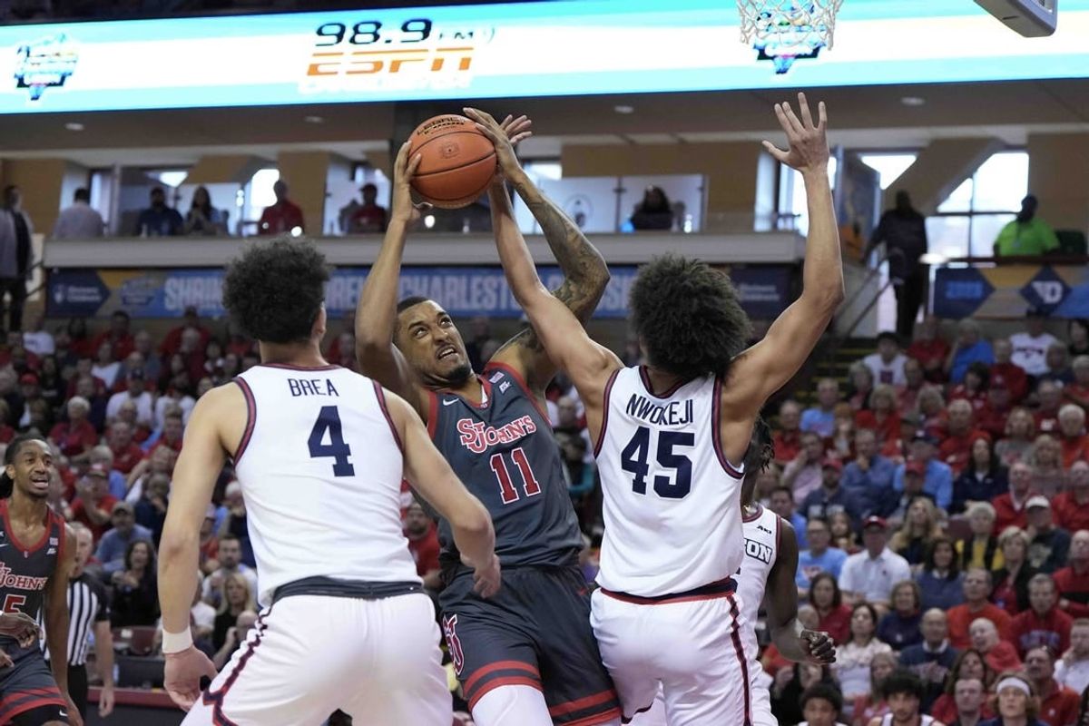 Nov 17, 2023; Charleston, SC, USA; St. John's Red Storm center Joel Soriano (11) is fouled by Dayton Flyers forward Zimi Nwokeji (45) in the first half at TD Arena.