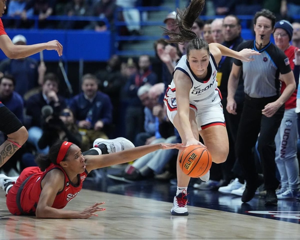 Feb 21, 2023; Hartford, Connecticut, USA; St. John's Red Storm forward Danielle Patterson (3) and Connecticut Huskies guard Caroline Ducharme (33) reach for a loose ball during the second half at XL Center.