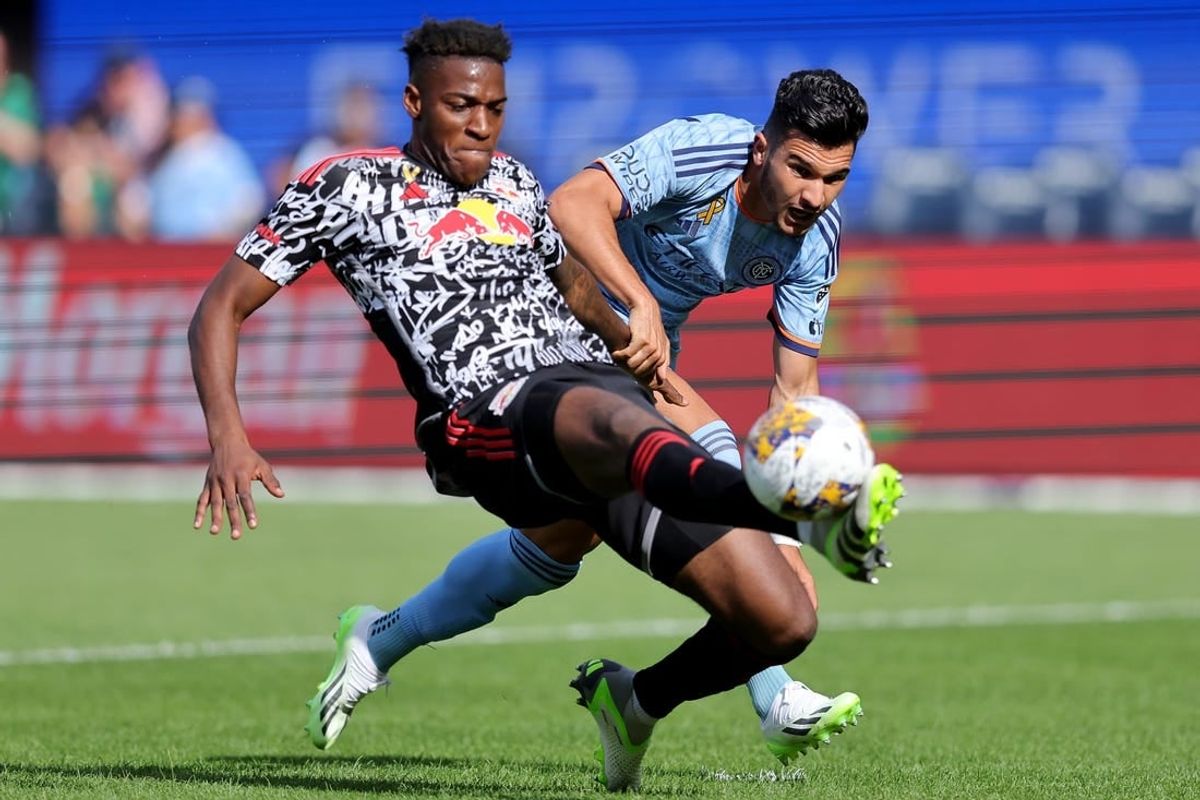 Sep 16, 2023; New York, New York, USA; New York Red Bulls defender Hassan Ndam (98) plays the ball against New York City FC forward Mounsef Bakrar (9) during the first half at Yankee Stadium.