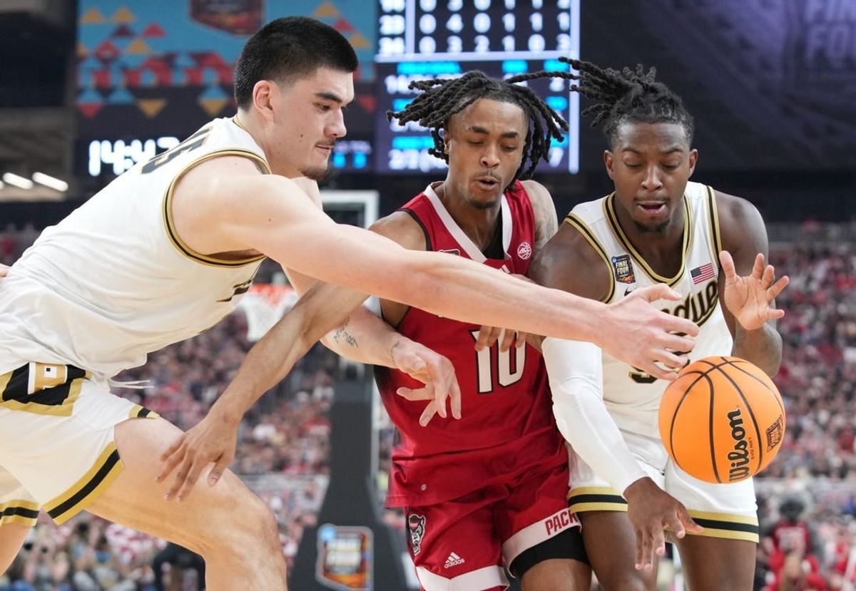 Purdue Boilermakers center Zach Edey (15), North Carolina State Wolfpack guard Breon Pass (10) and Purdue Boilermakers guard Lance Jones (55) during the NCAA Men’s Basketball Tournament Final Four game, Saturday, April 6, 2024, at State Farm Stadium in Glendale, Ariz.