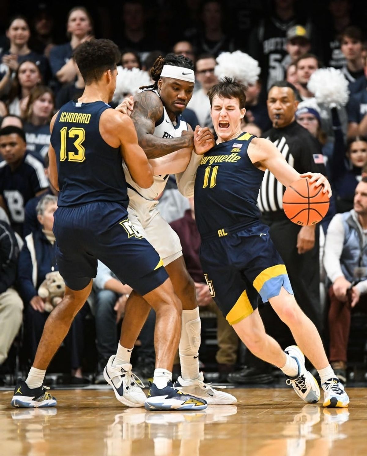 Feb 13, 2024; Indianapolis, Indiana, USA; Butler Bulldogs guard Jahmyl Telfort (11) fouls Marquette Golden Eagles guard Tyler Kolek (11) during the first half at Hinkle Fieldhouse.