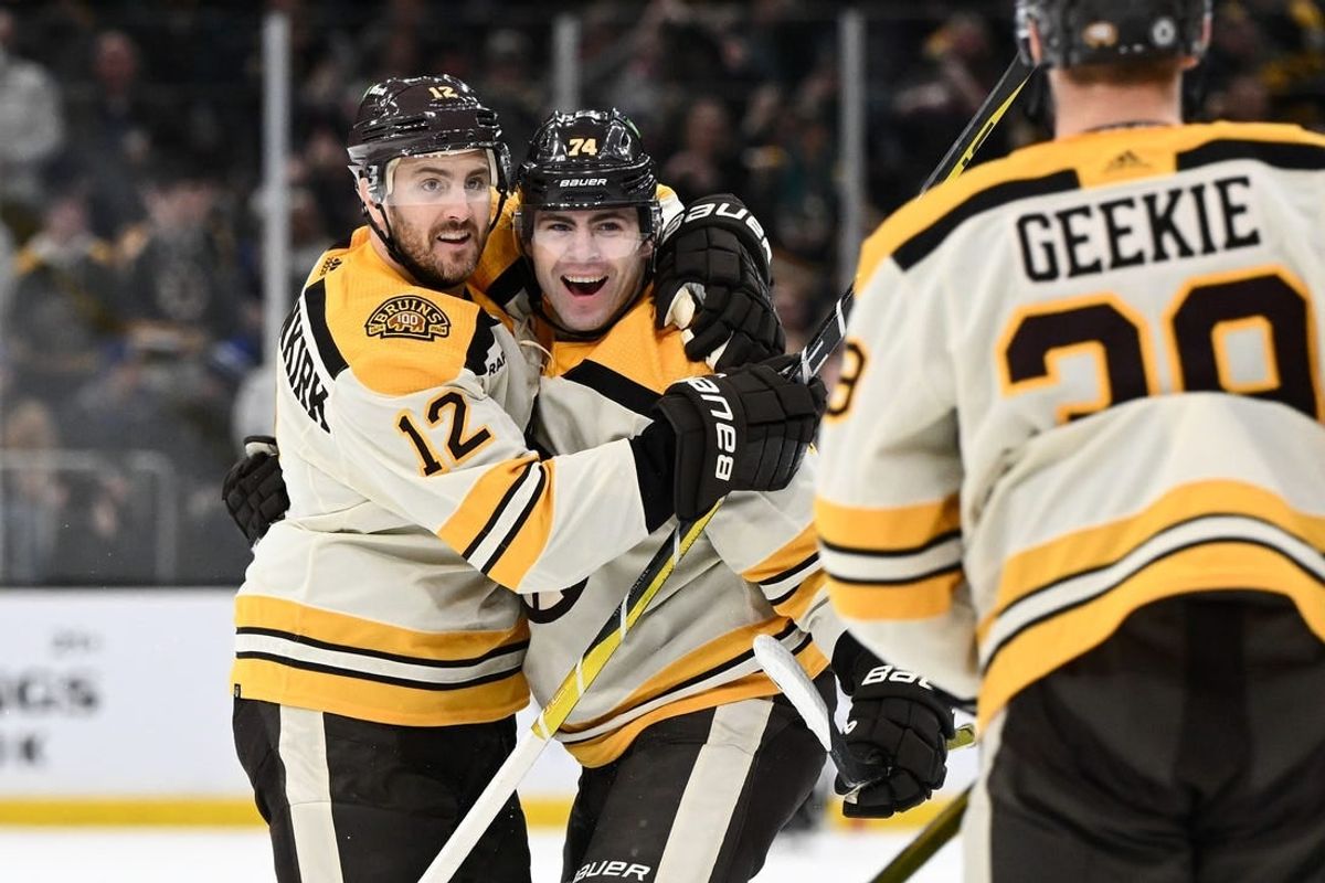 Mar 21, 2024; Boston, Massachusetts, USA; Boston Bruins left wing Jake DeBrusk (74) celebrates with defenseman Kevin Shattenkirk (12) and center Morgan Geekie (39) after scoring a goal against the New York Rangers during the first period at the TD Garden.