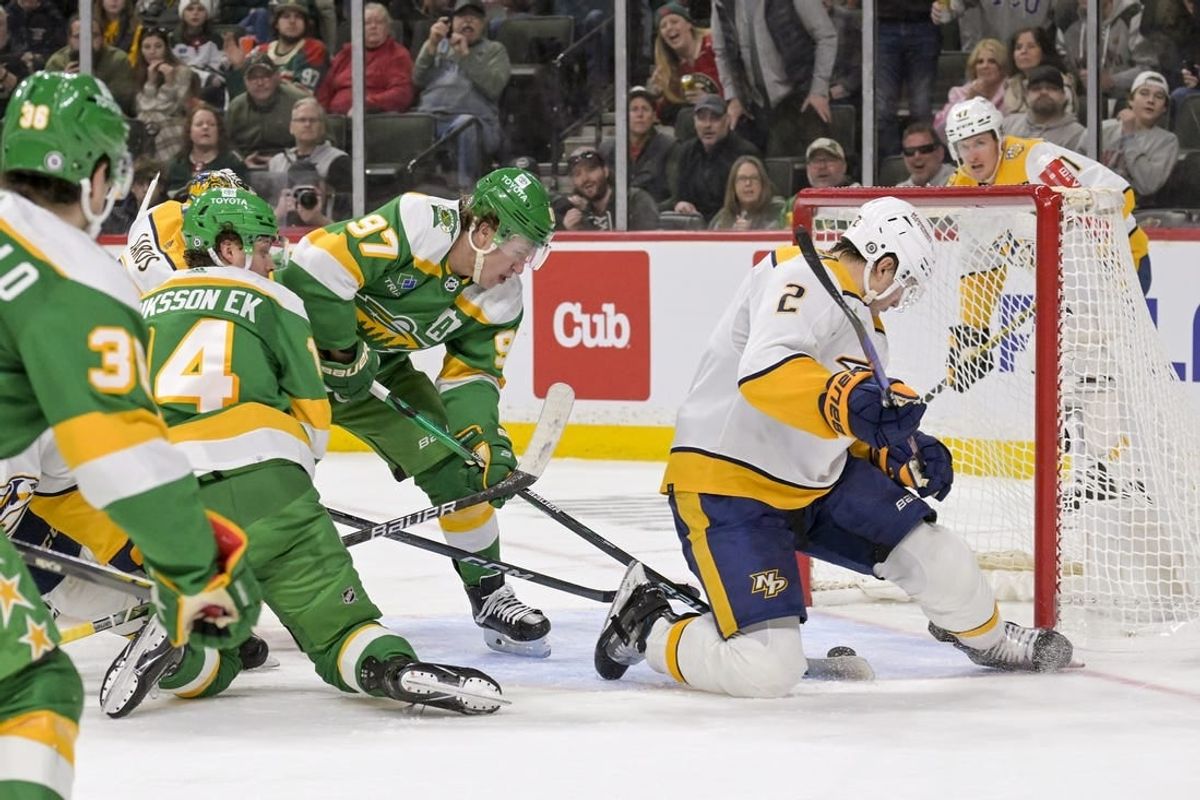 Mar 10, 2024; Saint Paul, Minnesota, USA;  Minnesota Wild forward Kirill Kaprizov (97) scores a power play goal as Nashville Predators defenseman Luke Schenn (2) looks for the puck during the second period at Xcel Energy Center.