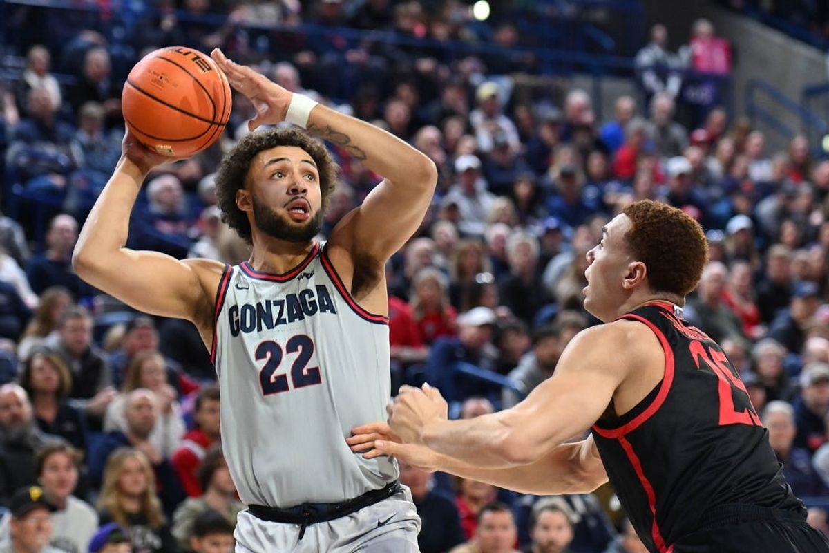 Dec 29, 2023; Spokane, Washington, USA; Gonzaga Bulldogs forward Anton Watson (22) shoots the ball against San Diego State Aztecs forward Elijah Saunders (25) in the first half at McCarthey Athletic Center.
