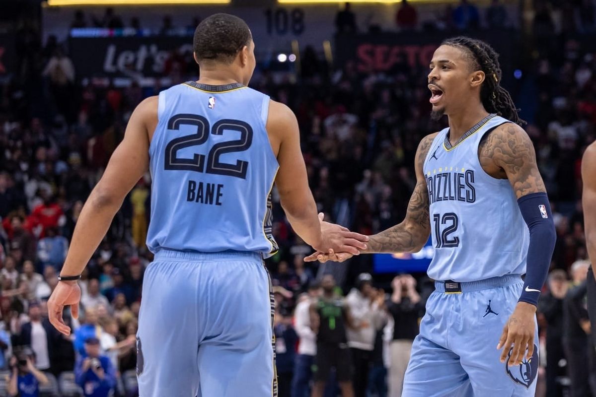 Dec 26, 2023; New Orleans, Louisiana, USA; Memphis Grizzlies guard Ja Morant (12) celebrates going to overtime with guard Desmond Bane (22) against the New Orleans Pelicans during the second half at Smoothie King Center.