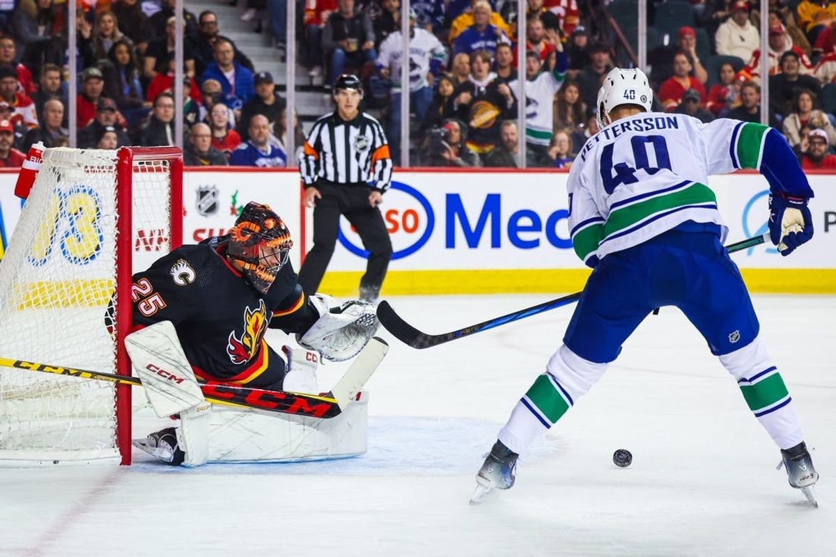 Dec 2, 2023; Calgary, Alberta, CAN; Calgary Flames goaltender Jacob Markstrom (25) guards his net against Vancouver Canucks center Elias Pettersson (40) during the first period at Scotiabank Saddledome.