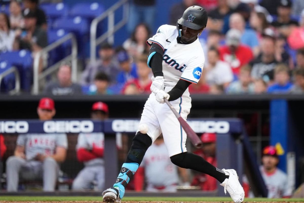 Apr 1, 2024; Miami, Florida, USA; Miami Marlins left fielder Nick Gordon (1) hits a single against the Los Angeles Angels during the first inning at loanDepot Park.