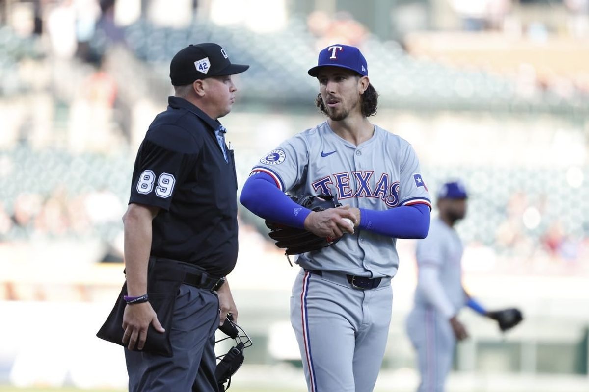 Apr 15, 2024; Detroit, Michigan, USA; Texas Rangers pitcher Michael Lorenzen talks with umpire Cory Blaser against the Detroit Tigers at Comerica Park.