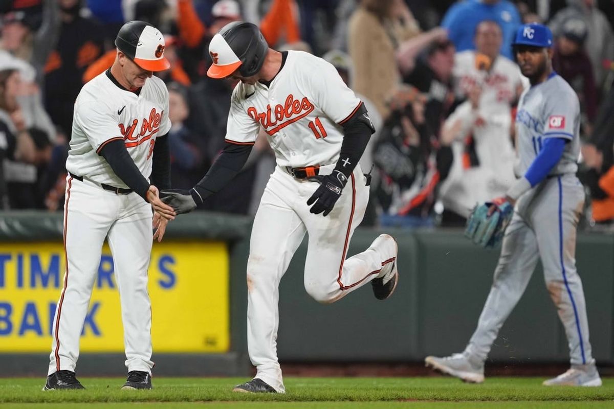 Apr 1, 2024; Baltimore, Maryland, USA; Baltimore Orioles designated hitter Jordan Westburg (11) greeted by coach Tony Mansolino (36) following his game winning two run home run in the ninth inning against the Kansas City Royals at Oriole Park at Camden Yards.