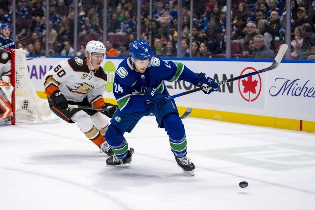 Mar 31, 2024; Vancouver, British Columbia, CAN; Anaheim Ducks defenseman Jackson LaCombe (60) defends against Vancouver Canucks forward Pius Suter (24) in the first period at Rogers Arena.