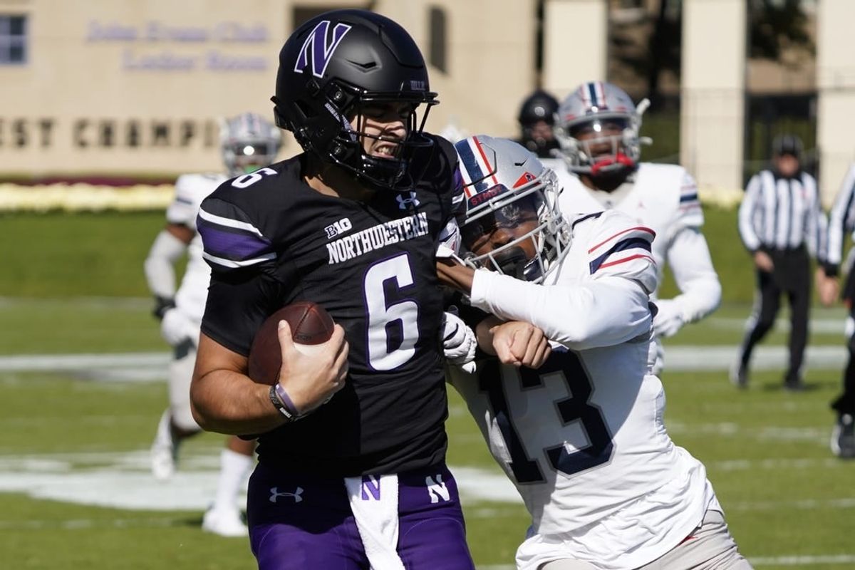 Oct 7, 2023; Evanston, Illinois, USA; Northwestern Wildcats quarterback Brendan Sullivan (6) runs for a touchdown as Howard Bison defensive back Jabari Knighten (13) defends him during the first half at Ryan Field.