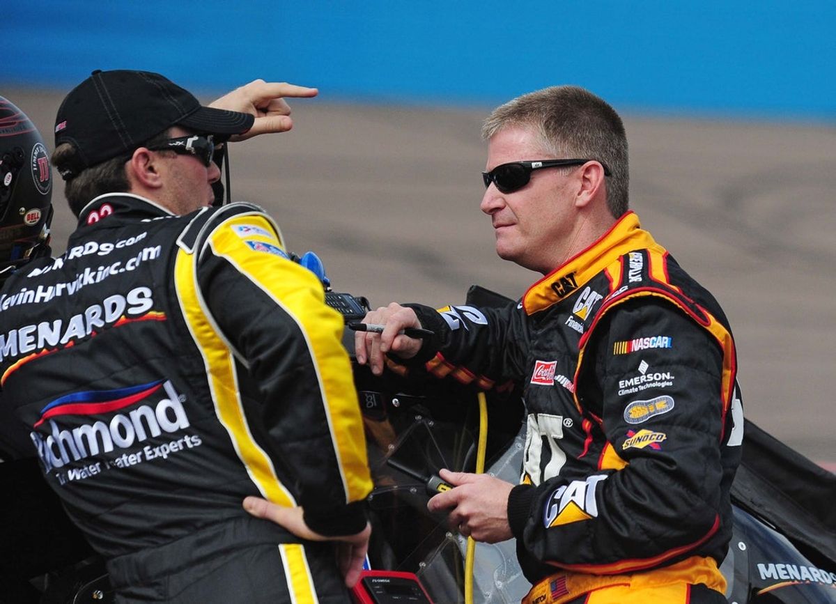 Feb. 26, 2011; Avondale, AZ, USA; NASCAR Sprint Cup Series driver Kevin Harvick (left) talks with Jeff Burton on pit road during qualifying for the Subway Fresh Fit 500 at Phoenix International Raceway. Mandatory Credit: Jennifer Stewart-Imagn Images