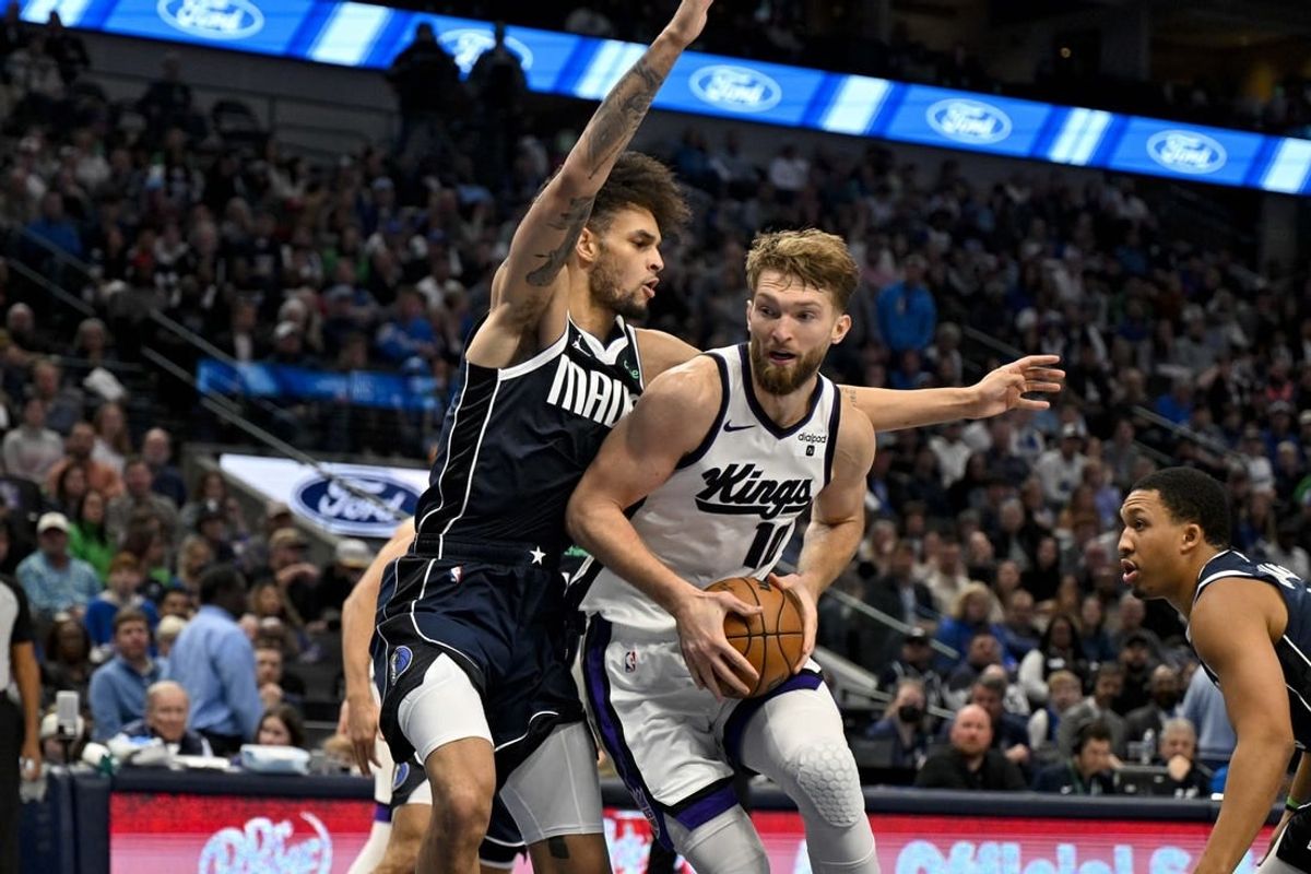 Nov 19, 2023; Dallas, Texas, USA; Sacramento Kings forward Domantas Sabonis (10) looks to move to the basket past Dallas Mavericks center Dereck Lively II (2) during the second half at the American Airlines Center.