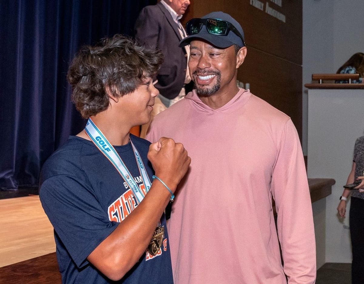 Benjamin School golfer Charlie Woods shows off his new ring to his father, Tiger Woods, during a ceremony to celebrate the boys golf team 2023 state championship on March 26, 2024 in Palm Beach Gardens, Florida.