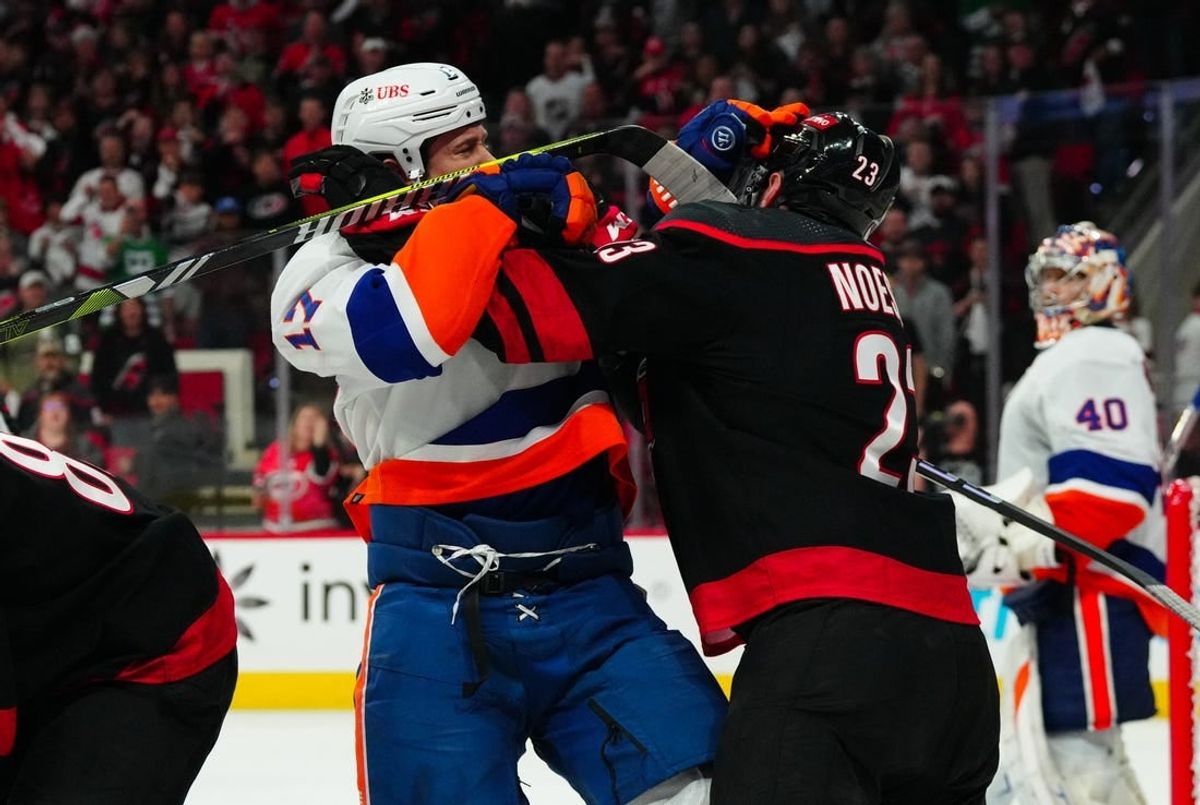 Apr 22, 2024; Raleigh, North Carolina, USA; Carolina Hurricanes right wing Stefan Noesen (23) and New York Islanders left wing Matt Martin (17) battle during the third period in game two of the first round of the 2024 Stanley Cup Playoffs at PNC Arena.