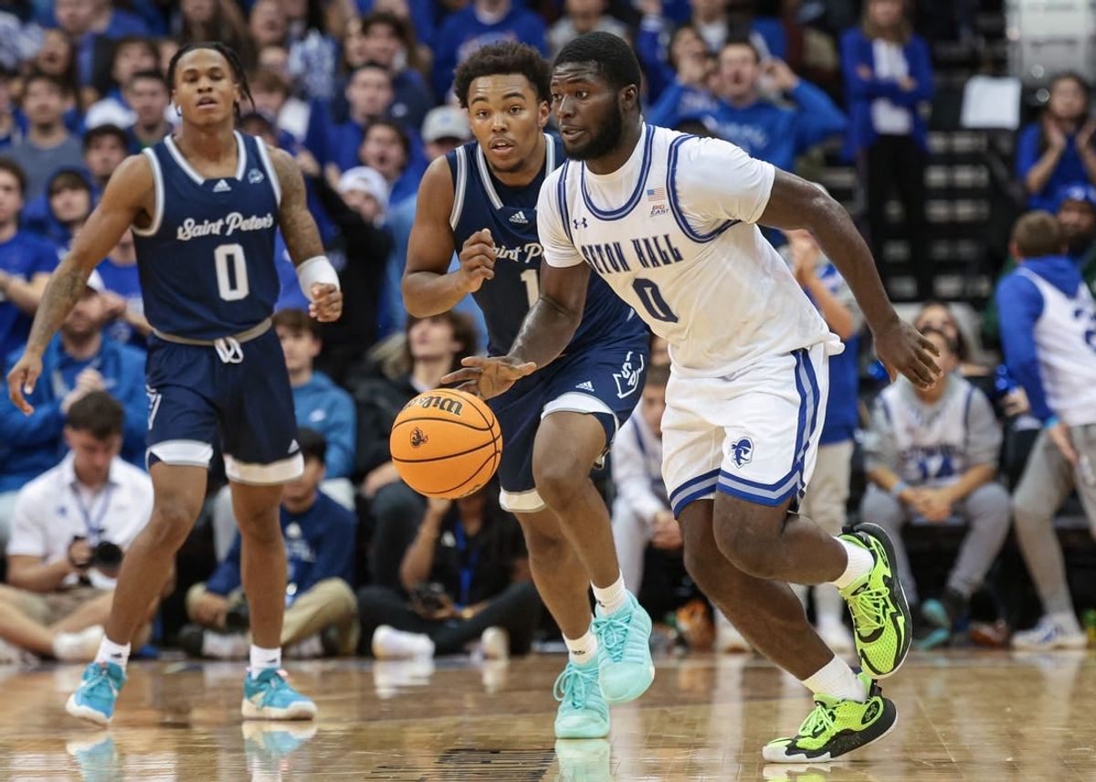 Nov 6, 2023; Newark, New Jersey, USA; Seton Hall Pirates guard Dylan Addae-Wusu (0) dribbles in front of St. Peter's Peacocks guard Brent Bland (1) and guard Latrell Reid (0) during the second half at Prudential Center.