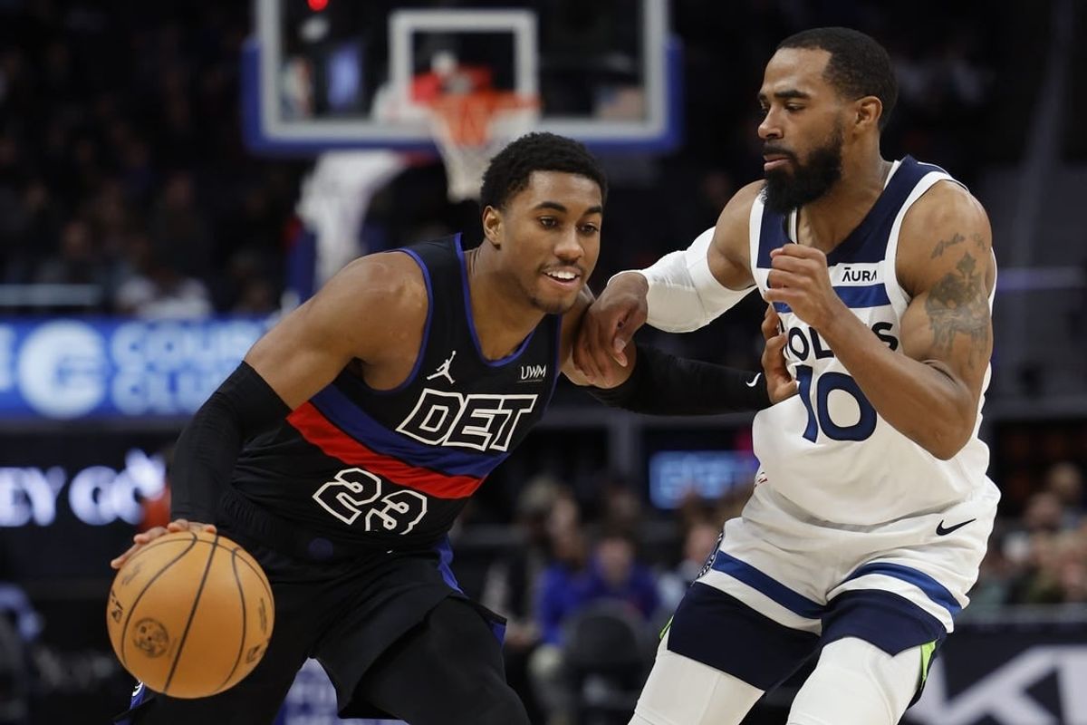 Jan 17, 2024; Detroit, Michigan, USA; Detroit Pistons guard Jaden Ivey (23) dribbles defended by Minnesota Timberwolves guard Mike Conley (10) in the second half at Little Caesars Arena.