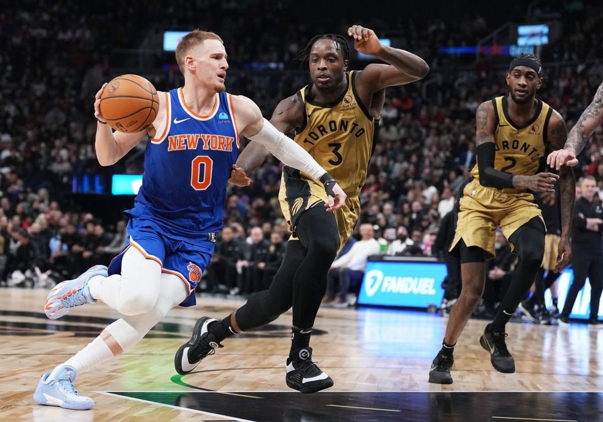 Dec 1, 2023; Toronto, Ontario, CAN; New York Knicks guard Donte DiVincenzo (0) controls the ball as Toronto Raptors forward O.G. Anunoby (3) tries to defend during the second quarter at Scotiabank Arena.