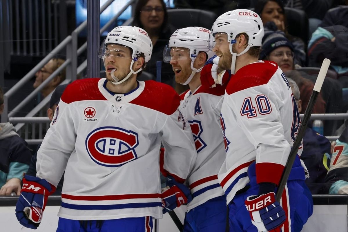 Mar 24, 2024; Seattle, Washington, USA; Montreal Canadiens defenseman Mike Matheson (8) celebrates with center Jake Evans (71, left) and right wing Joel Armia (40) after scoring a goal against the Seattle Kraken during the second period at Climate Pledge Arena.