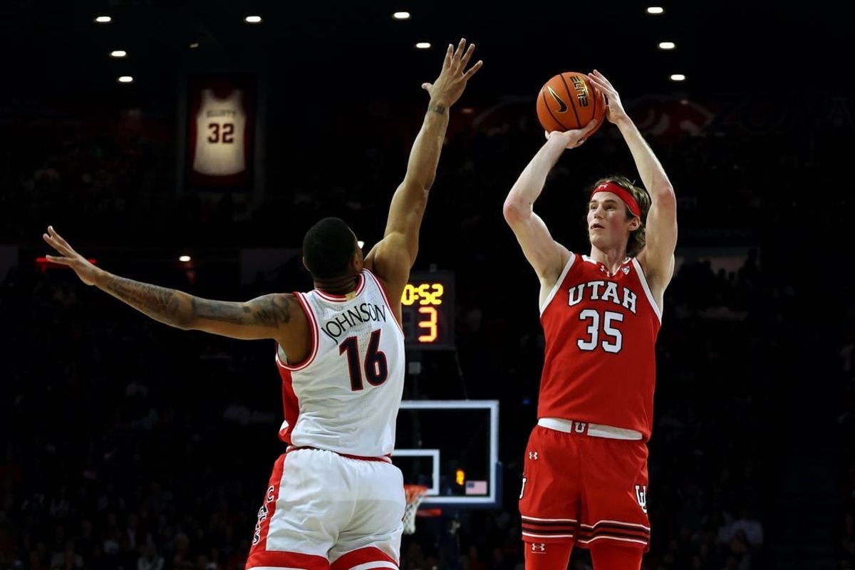 Jan 6, 2024; Tucson, Arizona, USA; Utah Utes center Branden Carlson (35) shoots a basket against Arizona Wildcats forward Keshad Johnson (16) during the first half at McKale Center.