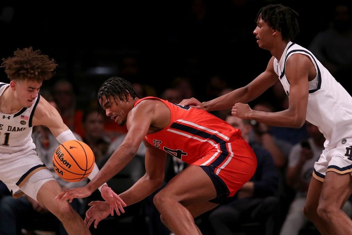 Nov 16, 2023; Brooklyn, New York, USA; Auburn Tigers center Dylan Cardwell (44) fights for the ball against Notre Dame Fighting Irish guard Braeden Shrewsberry (11) and forward Carey Booth (0) during the first half at Barclays Center.