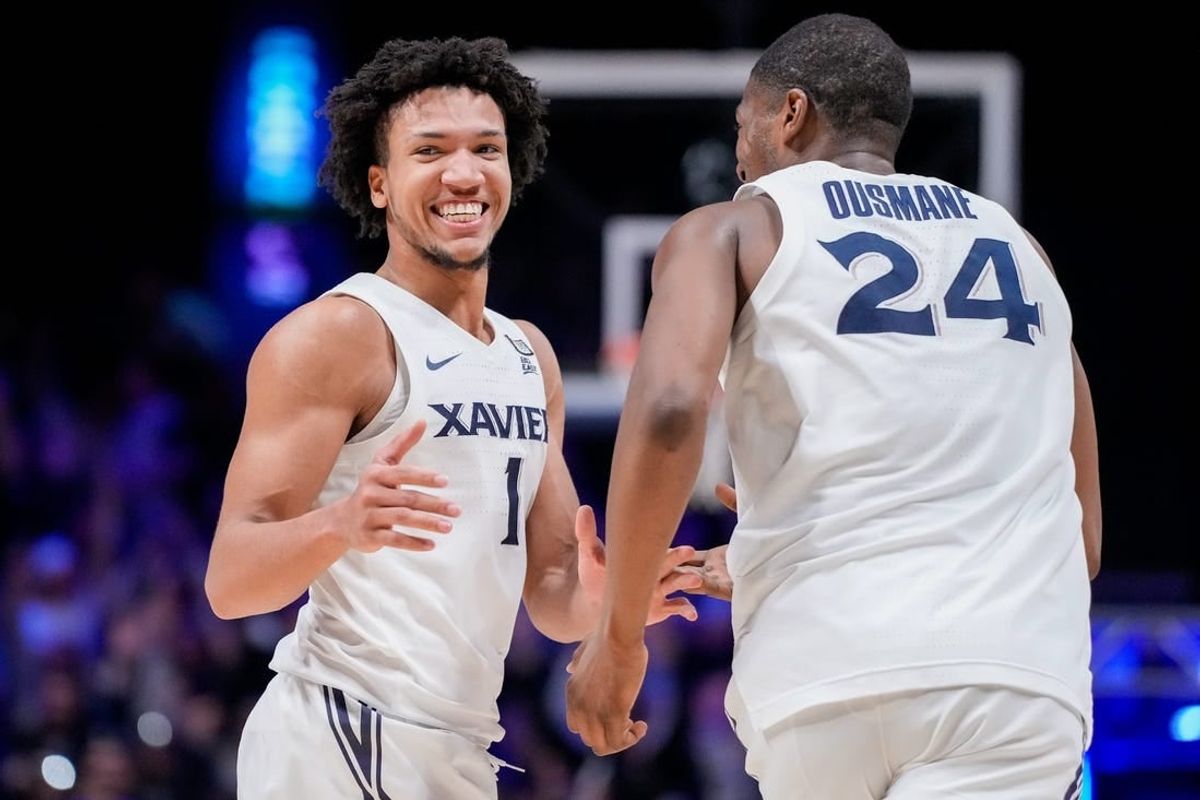 Xavier Musketeers guard Desmond Claude (1) and forward Abou Ousmane (24) celebrate a basket in the second half of the NCAA Big East basketball game between the Xavier Musketeers and the Butler Bulldogs at the Cintas Center in Cincinnati on Tuesday, Jan. 16, 2024. The Musketeers won 85-71.