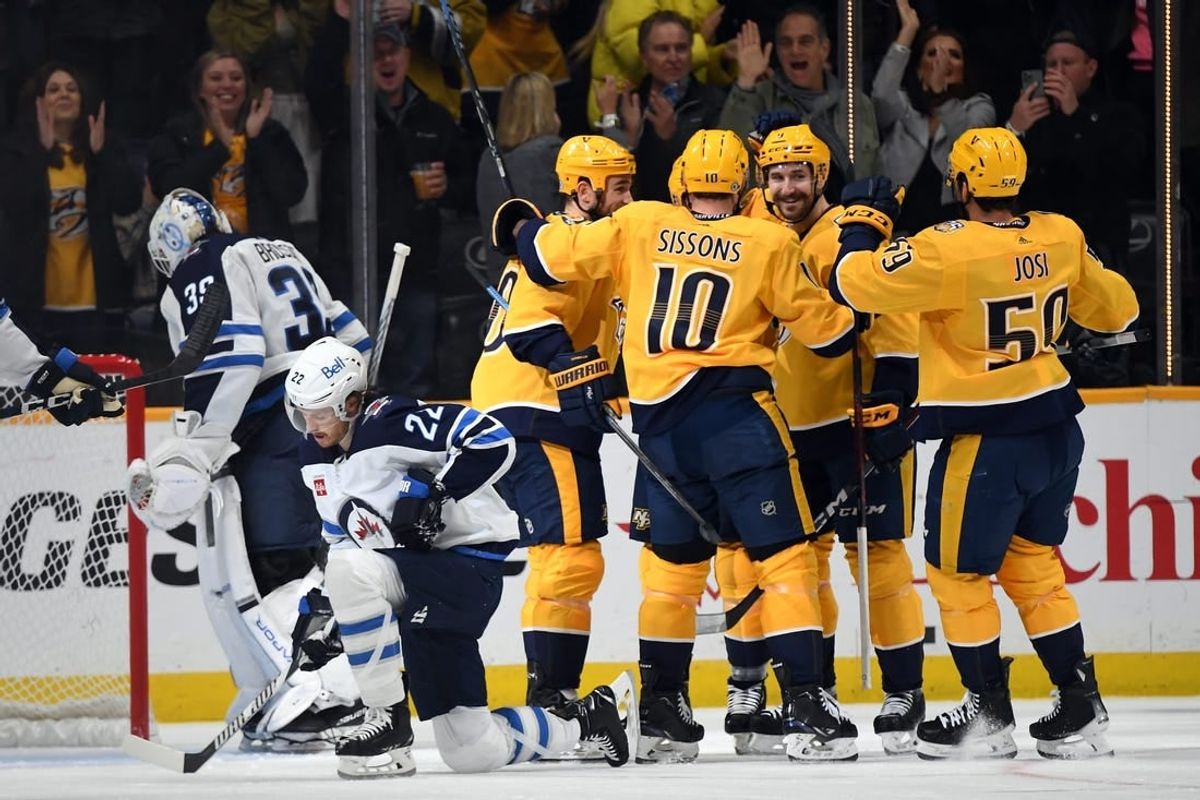 Nov 26, 2023; Nashville, Tennessee, USA; Nashville Predators players celebrate a goal by left wing Gustav Nyquist (14) during the second period against the Winnipeg Jets at Bridgestone Arena.