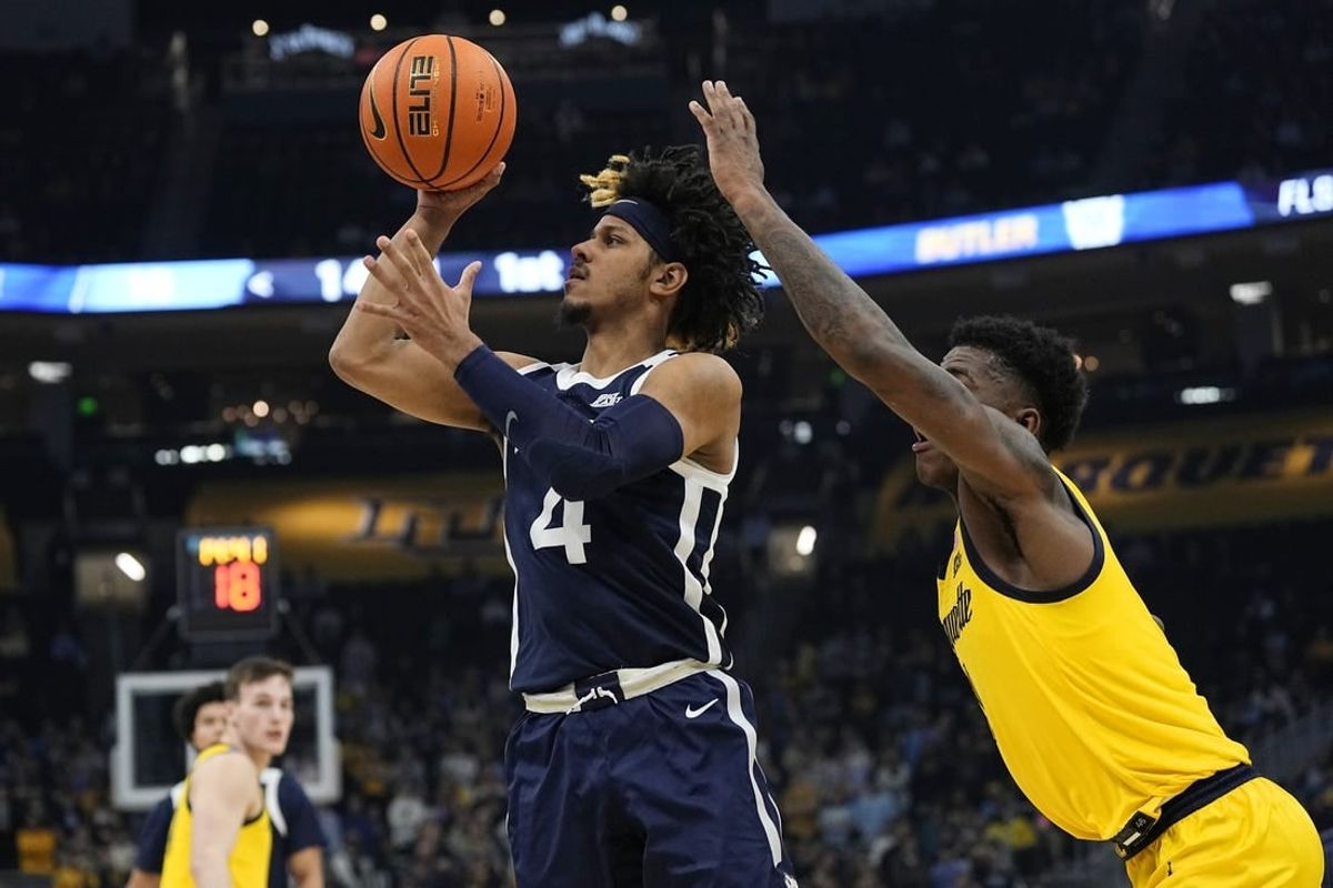 Jan 10, 2024; Milwaukee, Wisconsin, USA;  Butler Bulldogs guard DJ Davis (4) shoots in front of Marquette Golden Eagles guard Kam Jones (1) during the first half at Fiserv Forum.