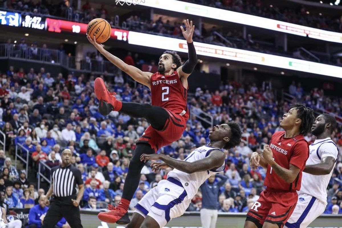 Dec 9, 2023; Newark, New Jersey, USA; Rutgers Scarlet Knights guard Noah Fernandes (2) drives past Seton Hall Pirates guard Kadary Richmond (1) for a layup in the first half at Prudential Center.