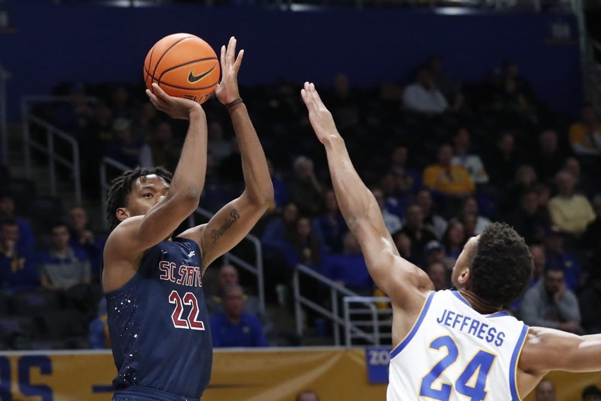 Dec 16, 2023; Pittsburgh, Pennsylvania, USA;  South Carolina State Bulldogs guard James Marrow (22) shoots against Pittsburgh Panthers forward William Jeffress (24) during the first half at Petersen Events Center.